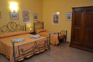 a bedroom with two beds and a cabinet at B&B Jolly house Bolognetta in Bolognetta