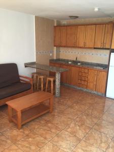 a kitchen with a couch and a table and a counter at Apartment Yumbo Centrum in Playa del Ingles