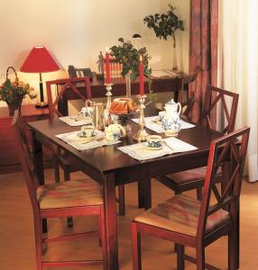 a dining room table with chairs and a table with a table at Mondial Appartement Hotel in Vienna