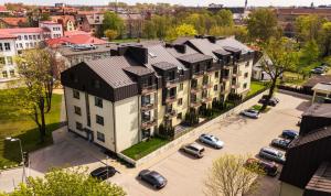 an aerial view of a building with cars parked in a parking lot at Comfort Stay - Klaipeda in Klaipėda