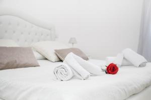 a white bed sitting next to a white pillow at Casa Marzia Affittacamere in Alghero