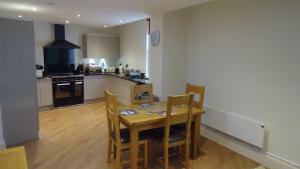 a kitchen with a table and chairs in a room at Hunter’s Retreat in York