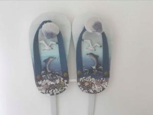 two toothbrushes with fish and birds on them at DELTA A - Piazza Marina - Vista mare in Lido di Jesolo