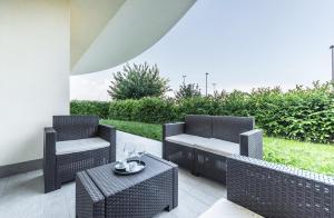 a patio with two chairs and a table at Tigli Suite in Marghera