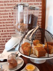 a table topped with a basket filled with donuts at Dom Dinis Marvão in Marvão
