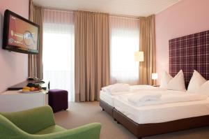 Postel nebo postele na pokoji v ubytování AKTIVHOTEL Weisser Hirsch