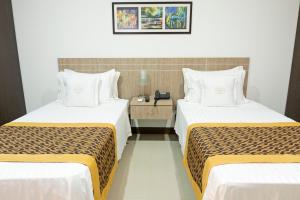 Ένα ή περισσότερα κρεβάτια σε δωμάτιο στο Hotel Cinco Monteria