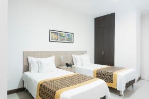 Ένα ή περισσότερα κρεβάτια σε δωμάτιο στο Hotel Cinco Monteria