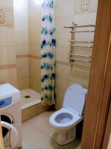 a bathroom with a toilet and a shower at Квартира in Almaty