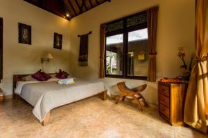 Postel nebo postele na pokoji v ubytování Bali Asli Lodge by EPS