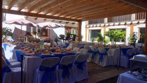 a banquet hall with blue tables and chairs at Hotel Santa Clara in San Cristóbal de Las Casas