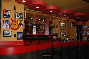 a bar in a restaurant with red counter tops at Algonquin Hotel in Sault Ste. Marie