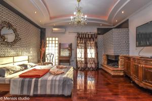 a bedroom with a large bed and a fireplace at Menios Apartments and Studios in Nea Kalikratia