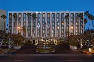 a large building with a clock on the front of it at Hyatt Regency John Wayne Airport Newport Beach in Newport Beach