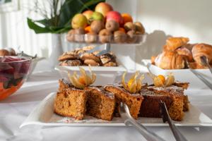 a table with a plate of bread and other desserts at Europa Royale Druskininkai in Druskininkai