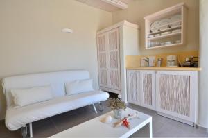 a living room with a couch and a table at Portes Houses in Koufonisia