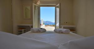 a bedroom with a large bed with towels on it at Portes Houses in Koufonisia