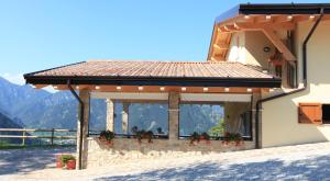 a building with a gazebo with flowers on it at Agriturismo Al Franet in Tremosine Sul Garda