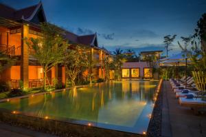 a swimming pool in front of a building at Khmer House Resort in Siem Reap