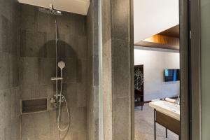 a bathroom with a shower and a sink at ARTOTEL Haniman Ubud in Ubud