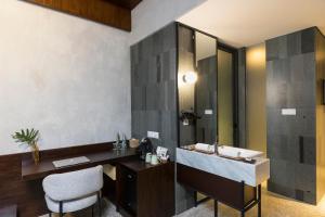 a bathroom with a sink and a mirror at ARTOTEL Haniman Ubud in Ubud