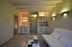 a living room with a couch and a table at Portes Houses in Koufonisia