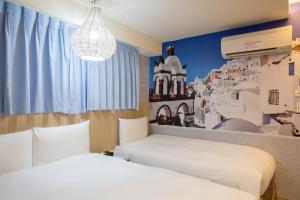 Katil atau katil-katil dalam bilik di Morwing Hotel - Culture Vogue
