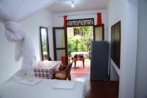 a room with a room with a table and a door at Holiday Home Bentota in Bentota