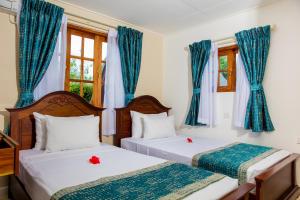 Postel nebo postele na pokoji v ubytování La Digue Island Lodge