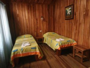 Ένα ή περισσότερα κρεβάτια σε δωμάτιο στο Hotel El Amanecer