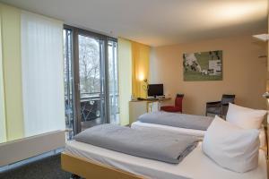 Cama o camas de una habitación en JUFA Hotel Wangen im Allgäu
