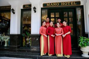 a group of people standing in front of a hotel at Maro Hotel in Hanoi