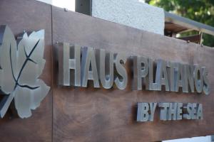 a sign for a building with the name of a pharmacy at Haus Platanos Apartments & Bungalows by the Sea in Vourvourou