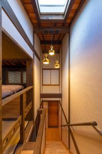 a room with a balcony with a bed and a window at Yoshimigura Machiya House in Kyoto