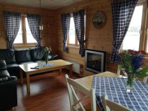 a living room with a couch and a table at Adventure Camp Mehamn in Mehamn