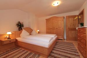 a bedroom with a bed and a dresser and a drawer at Pension Gatterer in Maria Luggau