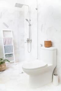 a white bathroom with a toilet and a shower at Jasmine Garden in Hoi An +24 photos