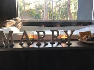 a table with candles and a sign that says marma at Spa Suites at RAVEN in Hepburn Springs