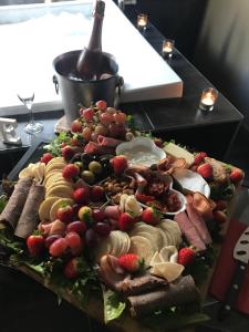 a platter of different types of food on a table at Spa Suites at RAVEN in Hepburn Springs