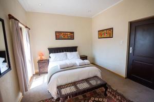 a bedroom with a large bed and a window at Catmandu in Dullstroom
