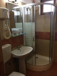 a bathroom with a sink and a shower at Motel Sora in Sovata +29 photos