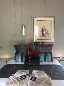 a bedroom with a bed with red string lights at Spa Suites at RAVEN in Hepburn Springs