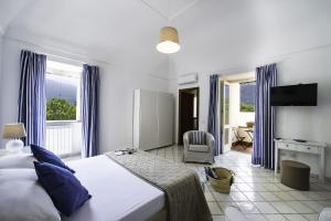 a bedroom with a large bed and a window at Casa Assunta B&B in Vico Equense