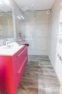 a bathroom with a red sink and a mirror at La Coulée Douce in Lanslevillard