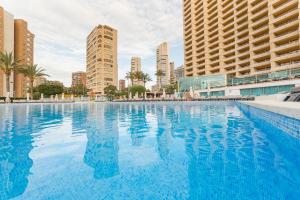 
a large swimming pool in a large city at Sandos Benidorm Suites in Benidorm
