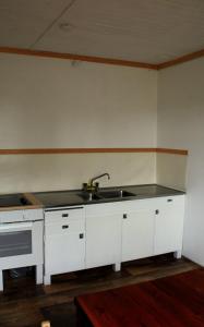 a kitchen with a sink and a counter top at Old timber house in Kalix