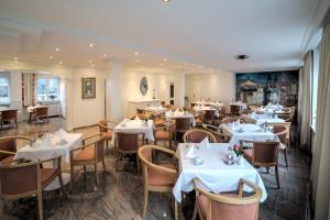 a restaurant with tables and chairs in a room at Hotel Central in Bregenz