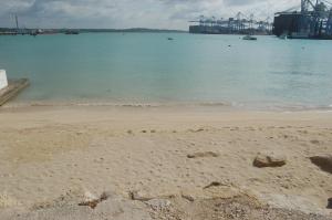 a beach with a body of water and a harbor at Water's Edge Hotel in Birżebbuġa