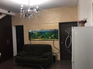 a living room with a couch and an aquarium at Bucharest Center Villa by ACME RENT in Bucharest