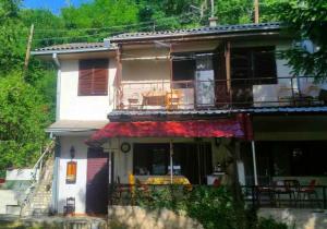 a house with a porch and a balcony at Melnicani, Breathtaking view in Debar +22 photos